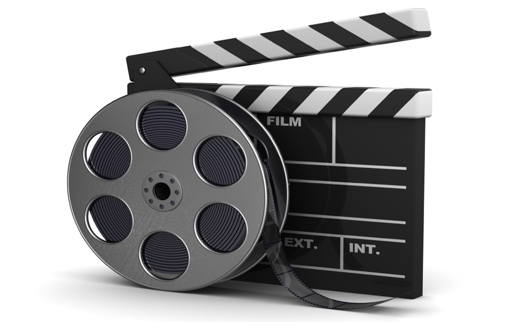 3d illustration of cinema clap and film reel, over white background
